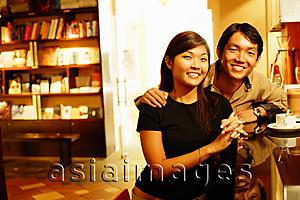 Asia Images Group - Couple at bar counter, looking at camera, portrait