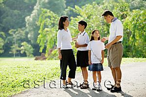 Asia Images Group - Family standing and talking in park