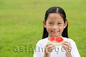 Asia Images Group - Girl holding slice of watermelon, smiling