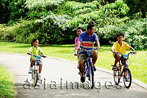 Asia Images Group - Family cycling in park
