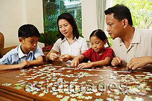 Asia Images Group -  Family playing with jigsaw puzzle, indoor