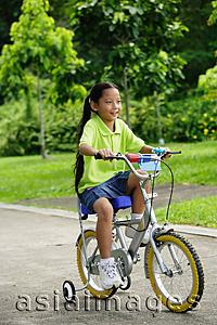 Asia Images Group - Young girl on bicycle