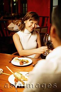 Asia Images Group - Couple toasting with wine at restaurant, over the shoulder view