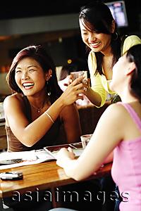 Asia Images Group - Young women at cafe, smiling