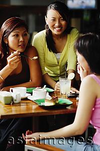 Asia Images Group - Young women eating at cafe