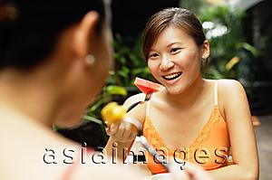 Asia Images Group - Two women eating, portrait
