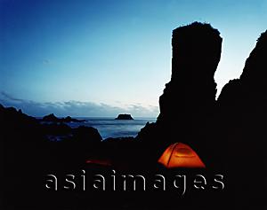 Asia Images Group - Tents under rock outcrop at night