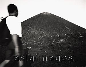 Asia Images Group - Asian male trekker on slopes of Krakatau volcano