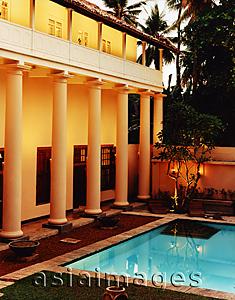 Asia Images Group - Exterior of building with garden and pool at night