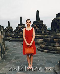 Asia Images Group - Eurasian model holding handbag at Borobudur temple