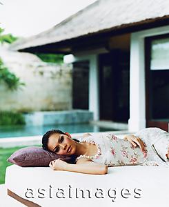 Asia Images Group - Eurasian female reclining on daybed