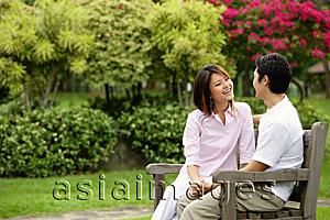 Asia Images Group - Couple on park bench, looking at each other