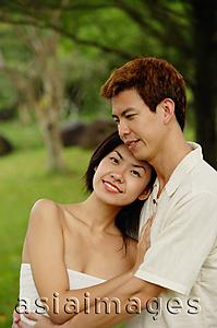 Asia Images Group - Couple embracing, woman looking at camera