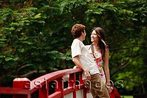 Asia Images Group - Couple standing face to face on bridge