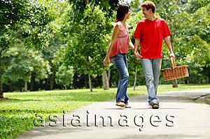 Asia Images Group - Couple walking in park, looking at each other