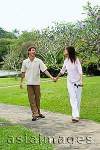 Asia Images Group - Couple walking hand in hand in park