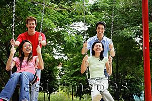 Asia Images Group - Couples in playground, women on swings, men pushing them