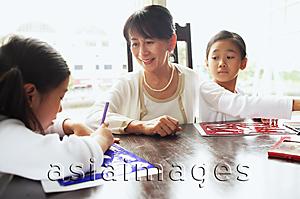 Asia Images Group - Grandmother with two girls, drawing