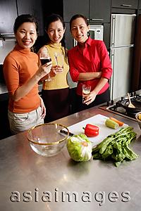 Asia Images Group - Women in kitchen, smiling at camera