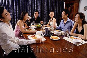 Asia Images Group - Adults at a dinner party, sitting around table