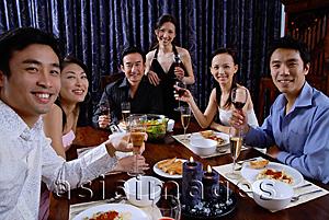 Asia Images Group - Couples at a dinner party, smiling at camera
