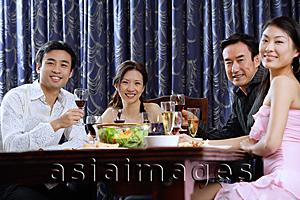 Asia Images Group - Couples having dinner at home, smiling at camera