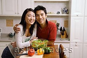 Asia Images Group - Couple leaning on kitchen counter, smiling at camera