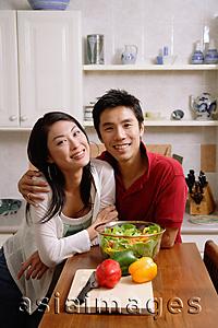 Asia Images Group - Couple side by side in kitchen, smiling at camera