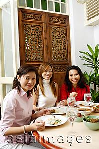 Asia Images Group - Women having a meal at restaurant, looking at camera