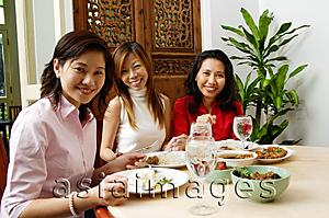 Asia Images Group - Three women having a meal at restaurant