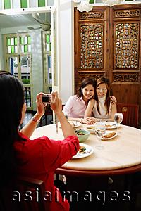 Asia Images Group - Woman taking pictures of friends