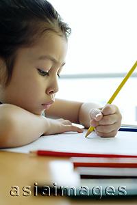 Asia Images Group - Young girl drawing, resting chin on arm, sideview