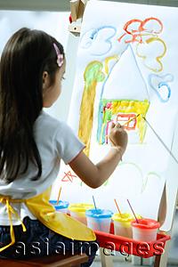 Asia Images Group - Young girl sitting in front of easel, painting