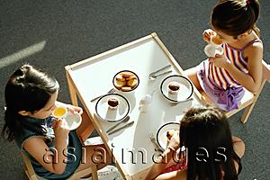 Asia Images Group - Three girls having a tea party