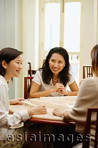 Asia Images Group - Women sitting around mahjong table, talking