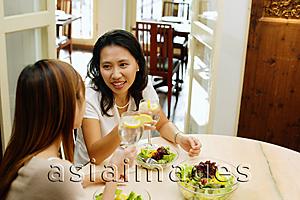 Asia Images Group - Women at a cafe, eating a salad lunch