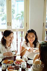 Asia Images Group - Three women having tea at cafe, high angle view
