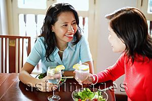 Asia Images Group - Women sitting at a cafe, having salad lunch