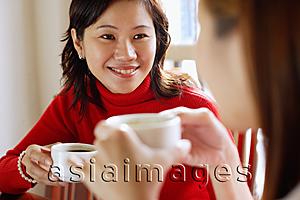 Asia Images Group - Women holding cups, sitting face to face