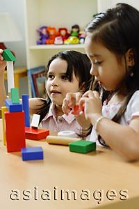 Asia Images Group - Two girls side by side, playing with building blocks