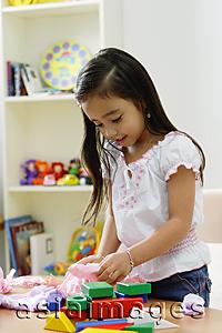 Asia Images Group - Young girl playing with toys