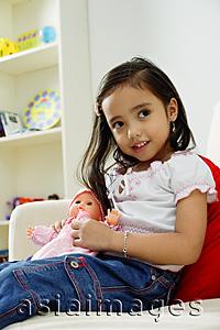 Asia Images Group - Young girl playing with doll, smiling