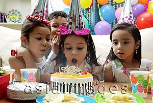 Asia Images Group - Birthday party, young girl blowing candles on cake