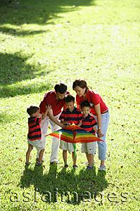 Asia Images Group - Family with three boys, outdoors with kite