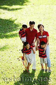 Asia Images Group - Family with three boys, standing on field, looking at camera