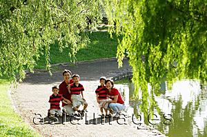 Asia Images Group - Family with three boys outdoors in park, smiling at camera