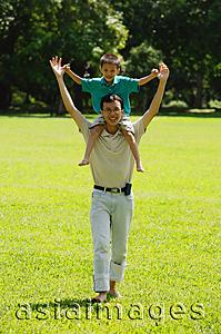 Asia Images Group - Father carrying son on shoulders