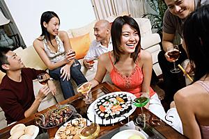 Asia Images Group - Adults having a party in living room