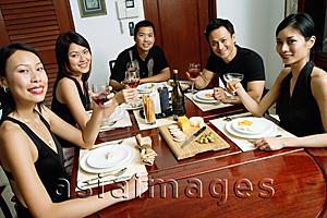 Asia Images Group - Adults having dinner party, holding drinks, smiling at camera