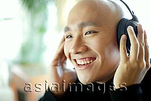 Asia Images Group - Man with headphones, listening to music